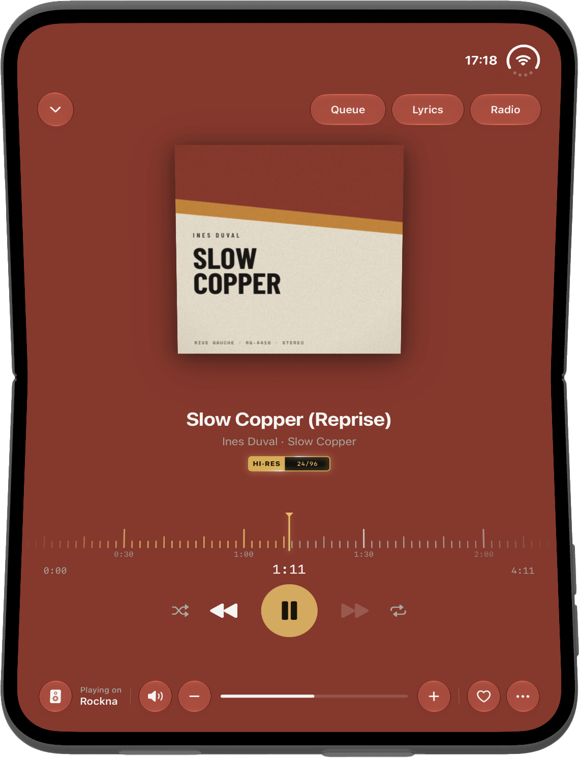 Now Playing on iPhone Duo standing on a table, the cover on top and the controls below